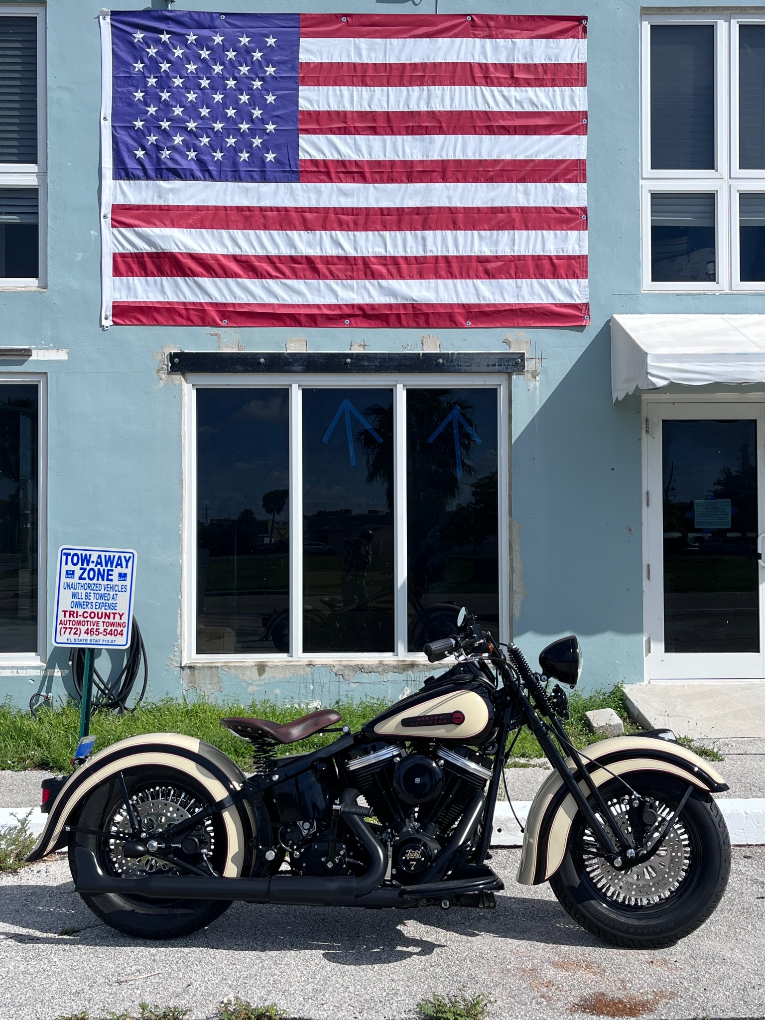 Harley-Davidson motorcycle displayed beneath an American flag