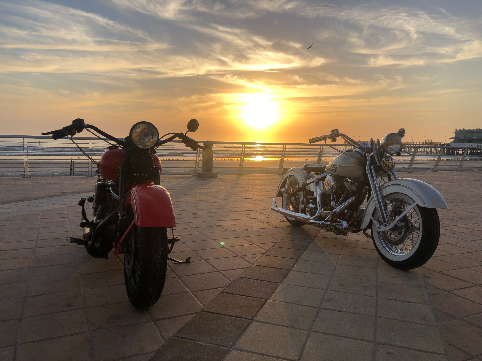 Two classic motorcycles at sunrise